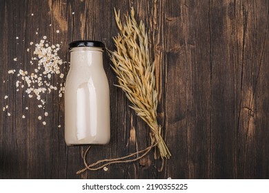 Plant Based, Lactose Free Milk. Homemade Oat Milk With Ingredients On Wooden Background. World Plant Milk Day. Copy Space