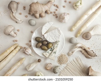 Plant Based Modern Still Life Flat Lay. Raw  Ingredients Set For Cooking On White Background: Asparagus, Mushrooms, Eggs, Noodles And Brie Cheese. Concept White On White. Overhead. Top View.