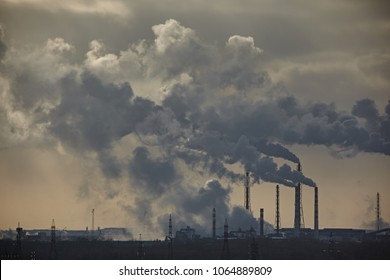 The plant emits smoke and smog from the pipes at mist cloudy, pollutants enter the atmosphere. Environmental disaster. Harmful emissions into. Exhaust gases. Chemical industry against the sky. - Shutterstock ID 1064889809