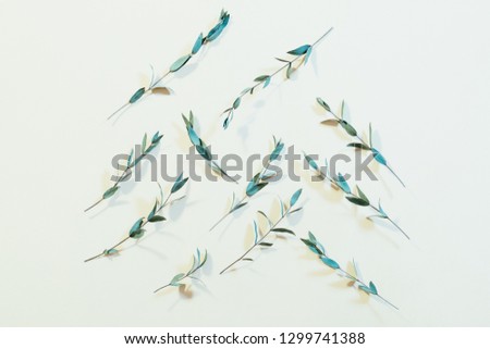 Plant pattern composition. Creative minimalism. Fresh stems on palegreen background.