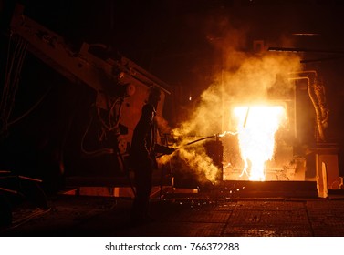 Plant for the production of steel. An electric melting furnace. Factory worker takes a sample for metal. - Shutterstock ID 766372288