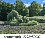 Plant sculpture of polar bear family made of plants at Mosaïculture exposition in Quebec city with an iceberg in the background