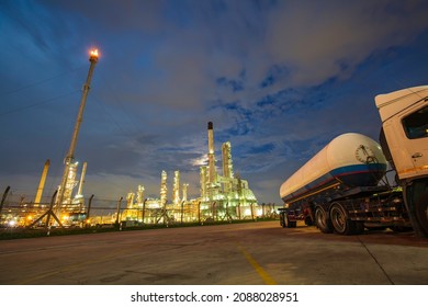 Oil​ refinery​ and​ plant and tower flare fire of Petrochemistry in ​industry transportation truck dangerous oil gas truck tank is parked in the factory.