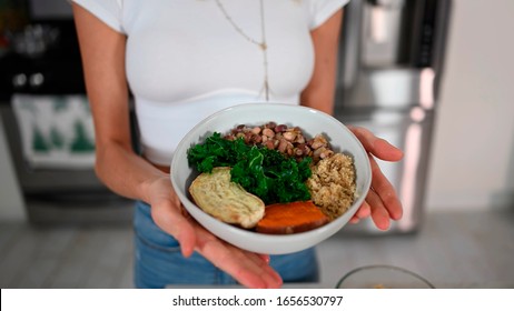 Plant-based Breakfast. Easy Vegan Meals For Busy Parents. Girl Holds A Dish In Front Of The Camera. Salad.