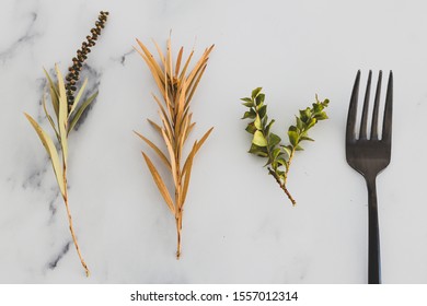 Plant-based Diet Conceptual Still-life, Fork Next To Group Of Mixed Plant Cuttings On Marble Table