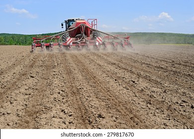 Planting Corn Trailed Planter In The Field 