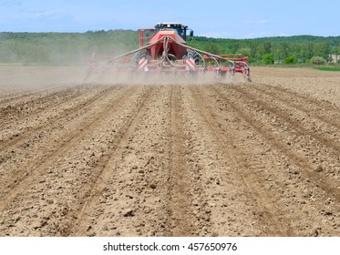 Planting Corn Trailed Planter In The Field 