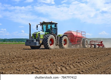 Planting Corn Trailed Planter In The Field 