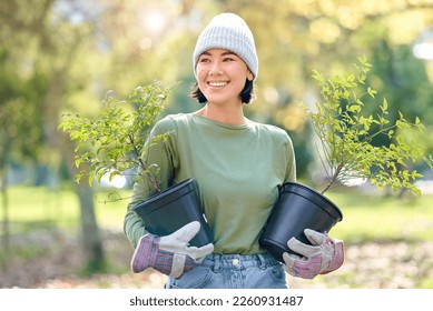 Plants, gardening and woman volunteering for agriculture, growth project and sustainability on earth day. Park, natural environment and community service worker, farmer or person with trees in forest - Powered by Shutterstock