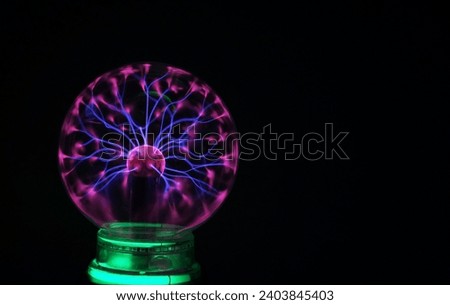 Plasma Globe in the dark projects alternating voltage electrons 