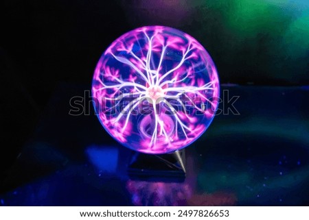 Plasma globe on dark background with vibrant pink and purple electric arcs, science, electricity, physics demonstration, educational toy, interactive plasma ball, high voltage, Tesla coil sphere power