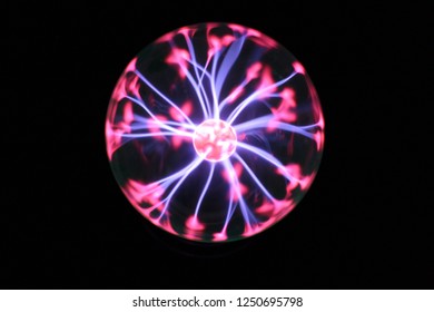 Plasma sphere lamp glowing in the dark. Electric lightning bolts moving around.