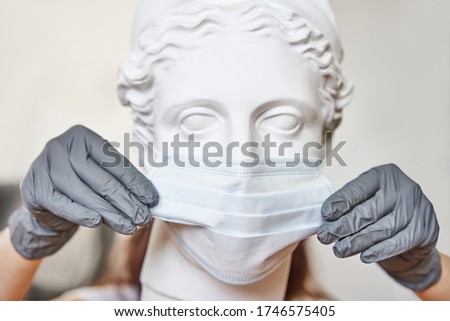A plaster bust in protective medical mask and latex glooves. Acute respiratory infections disease concept.Coronovirus. COVID-19. Flu.