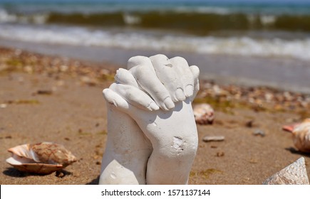 Plaster Cast Of Two Hands On The Seashore