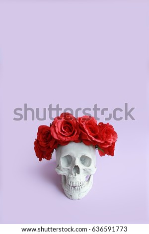 Plaster skull with red roses crown