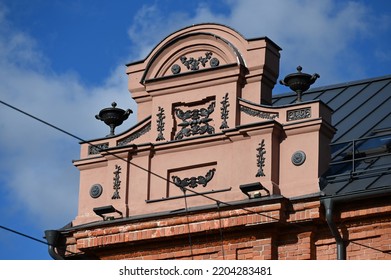 Plastered Pediment Of A Historical Building With Dark Decorative Elements