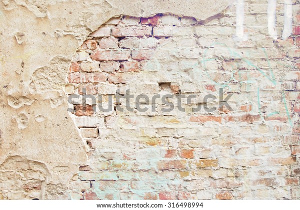 (plastered wall with) exposed brick wallpaper