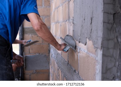 Plastering of plaster workers on the walls for building houses, repairing plaster, indoor walls and ceilings with floating and plastering