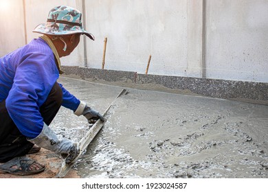 Plastering Work. The Tiler Is Working To Smooth The Cement Surface.