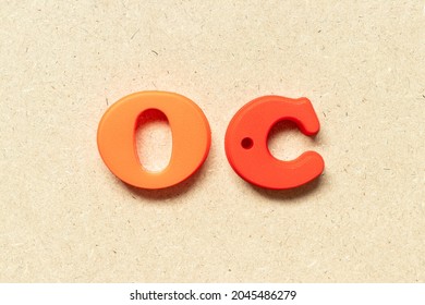 Plastic Alphabet Letter In Word OC (Abbreviation Of Opportunity Cost Or Original Content, Character) On Wood Background