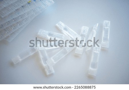 Plastic ampoules with eye drops on a white background.Eye drops on the table. A moisturizer for the cornea.