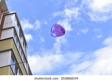 A Plastic Bag Flying In The Air Between Residential Buildings