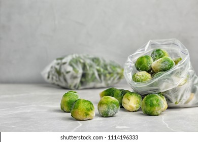 Plastic bag with frozen Brussel sprouts on table. Vegetable preservation