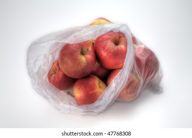 A Plastic Bag Of Gala Apples Isolated On White