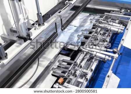 Plastic bag making machine, Packaging machinery, Plastic manufacturing, Industrial automation, Production line.