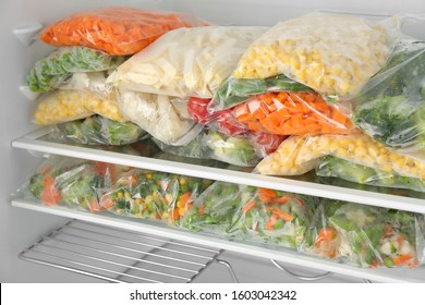 Plastic Bags With Different Frozen Vegetables In Refrigerator