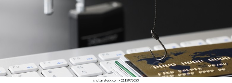 Plastic Bank Credit Cards And Fishhook On Computer Keyboard. Online Shopping Addiction Concept