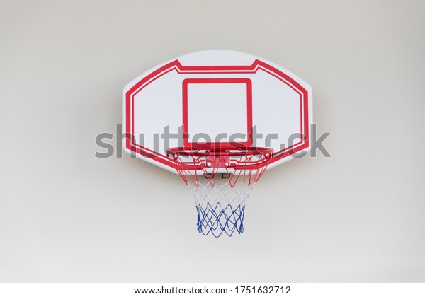 plastic basketball hoop on white concrete wall.\
sport equipment toy for\
kid.