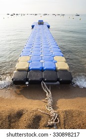 Plastic Blue Rotomolding Jetty In The Empty Sea Against Blue Sky.