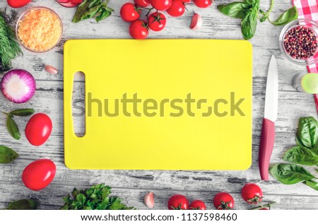 Plastic board for cutting vegetables. Lying on the table. There is room for your text.