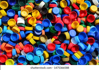 Plastic bottle caps background. Cap material is recyclable.Remove lids from plastic bottles before recycling them. Recycling collection and processing plastic bottle caps 