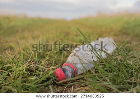Plastic bottle discarded in the grass 