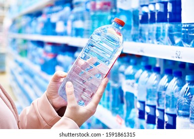 Plastic Bottle Drinking Water In Hands Buyer In Store