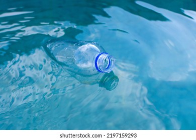 plastic bottle floats on the surface of the water. High quality photo
