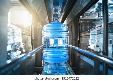 Plastic Bottle Or Gallon Of Purified Drinking Water Inside Automated Conveyor Production Line. Water Factory, Toned
