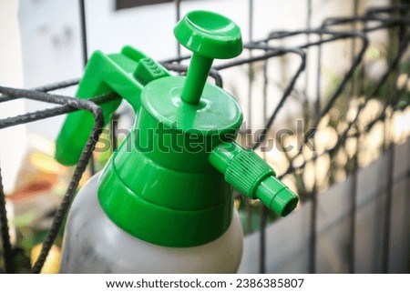 A plastic bottle hand pump pressure sprayer is designed for use in the garden to spray water or pesticides on plants.