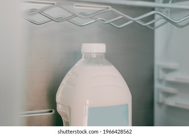 Plastic Bottle Of Milk With A Blank Blue Label Stands In A Fridge Alone. Mockup. Mock-up. Refrigerator. Beverage. Liquid. Storage