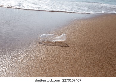 Plastic bottle on the beach - Shutterstock ID 2270109407