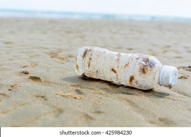 Plastic bottle is on the beach leave by tourist