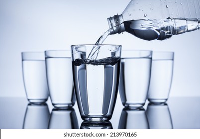 Plastic Bottle That Fill Up With Water Group Of Glasses On White Background