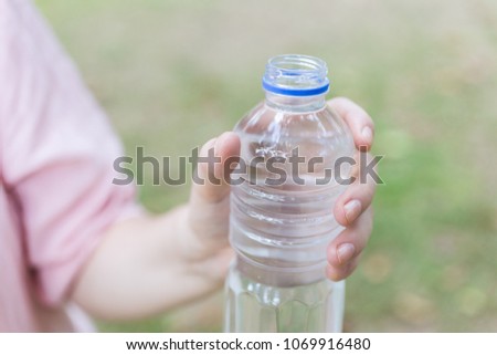 Plastic bottle with water in hand