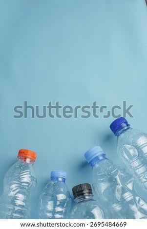 Plastic bottles arranged facing a small globe, symbolizing global pollution and environmental threat caused by plastic waste.