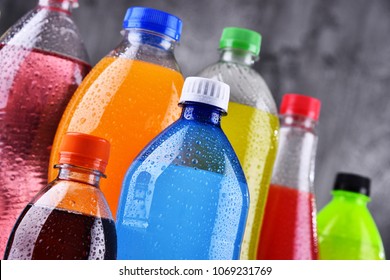 Plastic bottles of assorted carbonated soft drinks in variety of colors