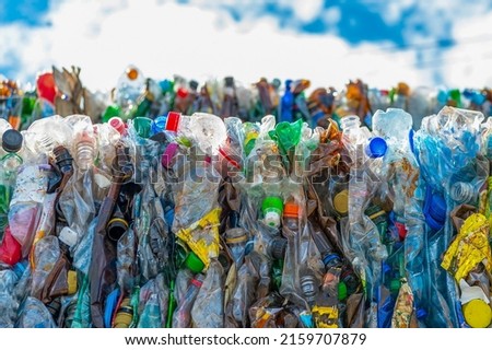 Plastic bottles in bales ready for recycling at a waste processing plant.  Sale, collection of plastic waste, environmental cleaning.