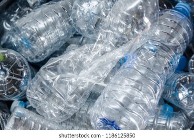 Plastic bottles in black garbage bags waiting to be taken to recycle.

