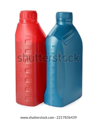 Plastic bottles with liquids on white background